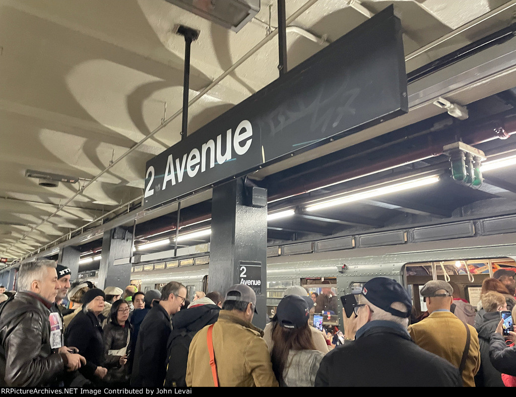 Crowd of people surrounding the Holiday Train at 2nd Ave Station 